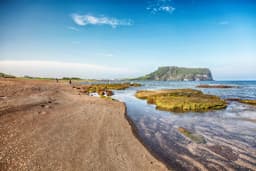 Full Day Tour to East Jeju Highlights: Sunrise Peak, Haenyeo & Lava Caves